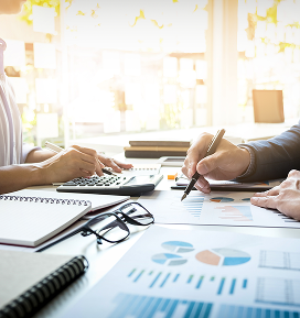 Business professionals analyzing financial reports and tax benefits for sustainable development projects