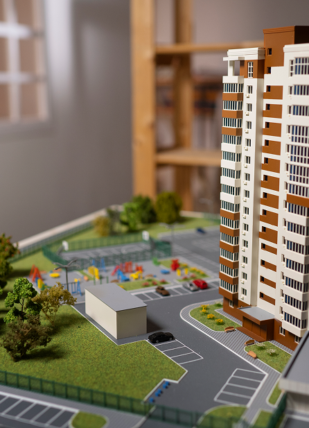 Modern Residential Development with Green Spaces and Community Amenities High-rise apartment model with landscaped parking, playground, and sustainable urban planning design